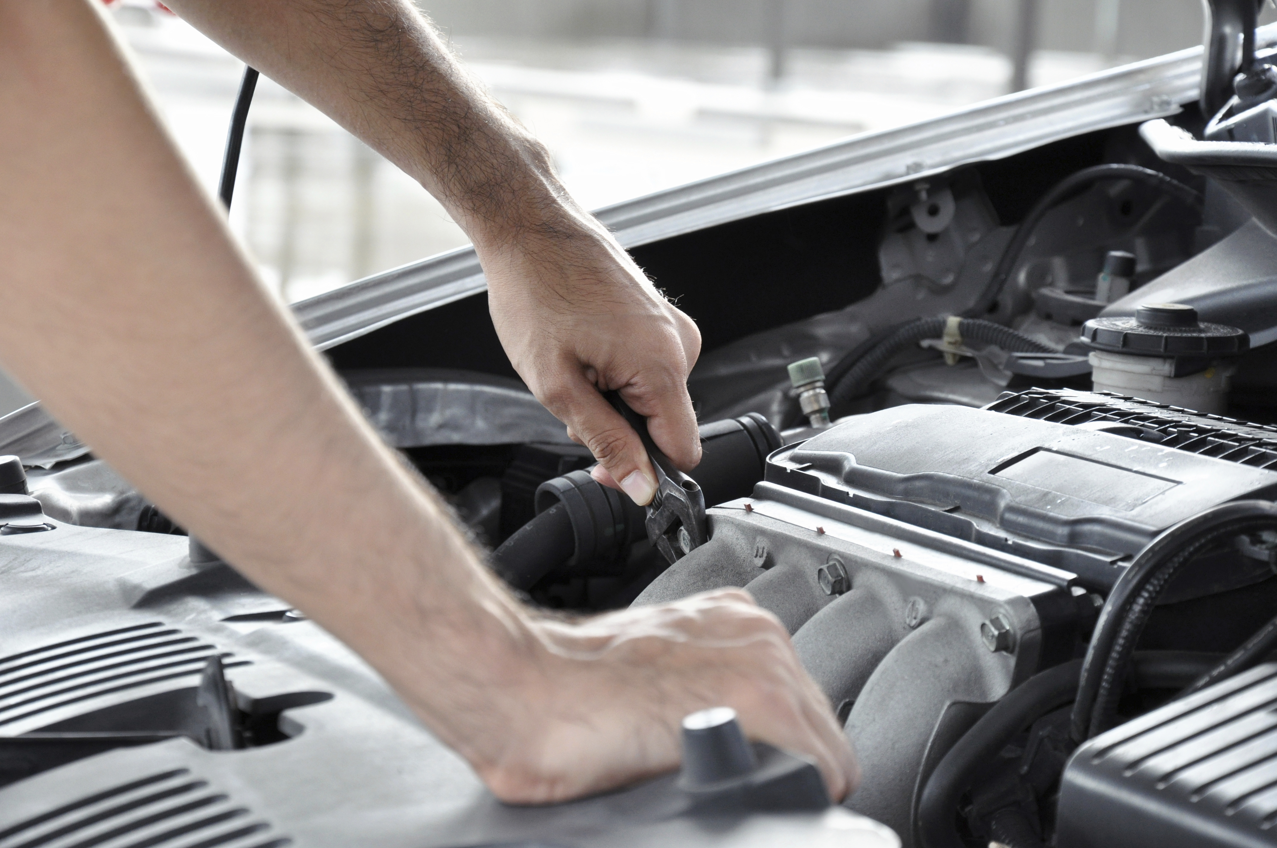 Mechanic checking car engine